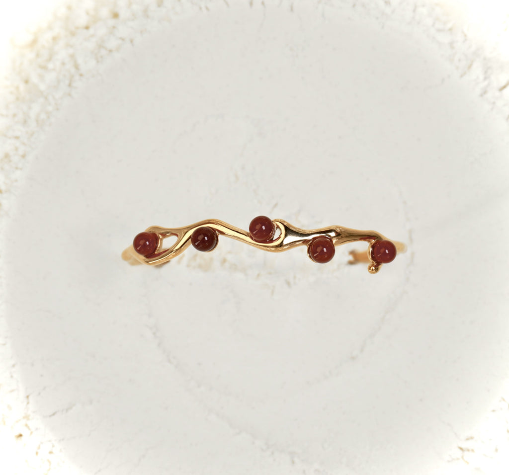 Astra bracelet by Mareas featuring deep red stones