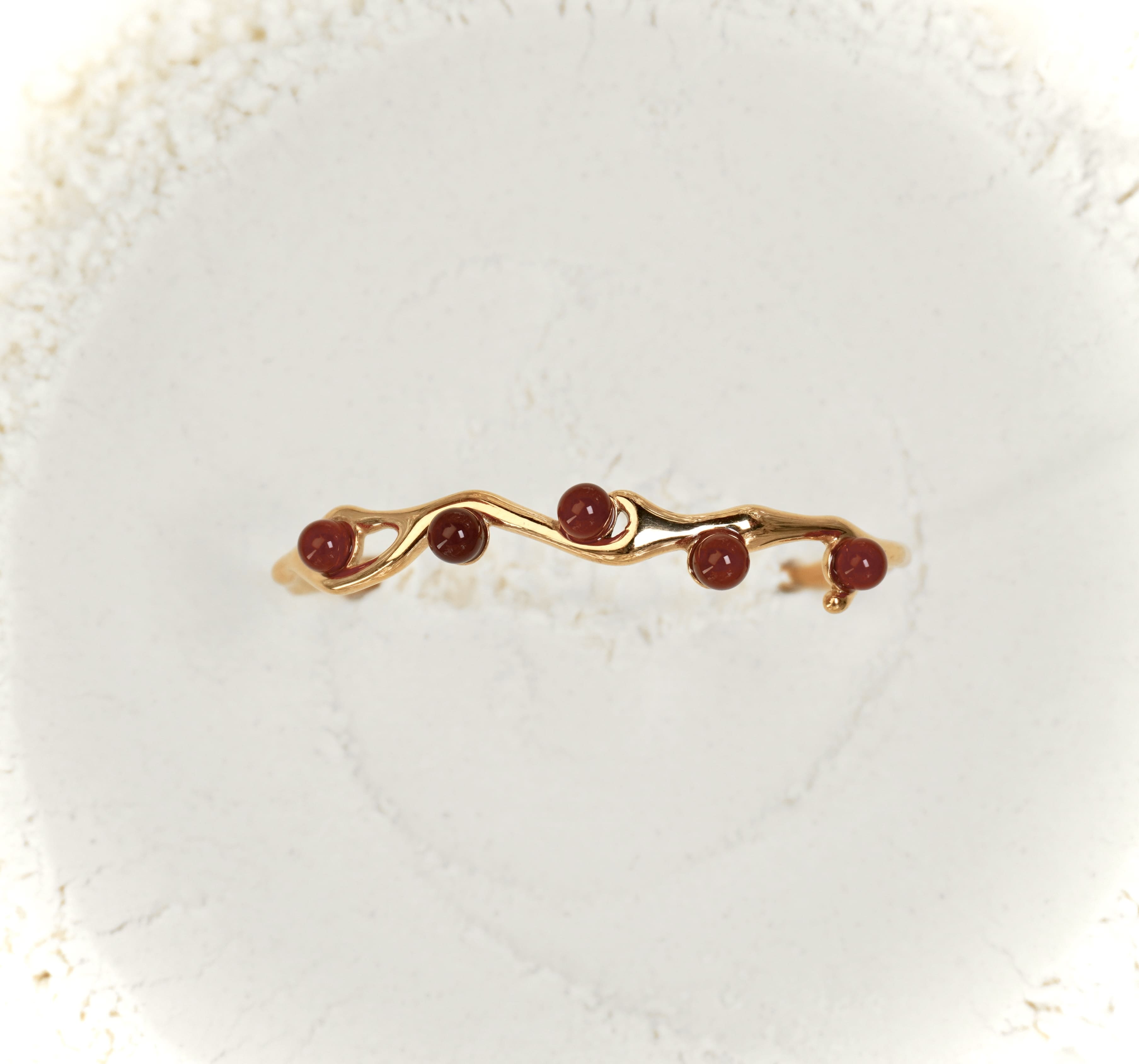 Astra bracelet by Mareas featuring deep red stones